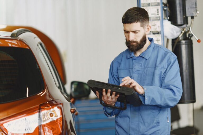 Mehaničar sa dijagnostičkim uređajem pored vozila – Auto Centar Radić Niš